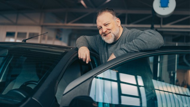 Mechanic leaning on a car